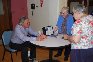 Greg O'Brien signing books at Elizabeth Seton Residence community presentation